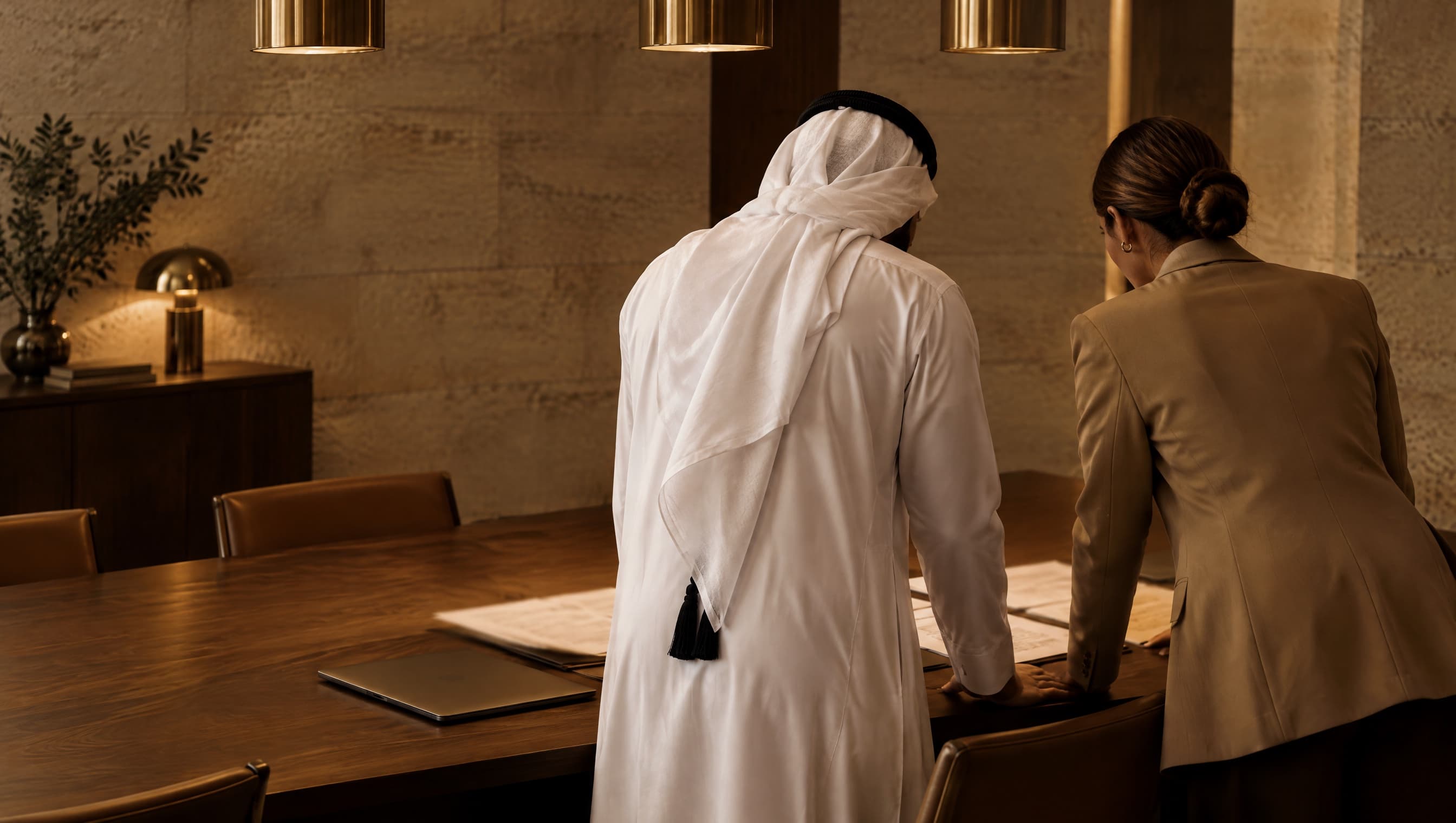Two co-founders reviewing draft founding documents in a new company office.