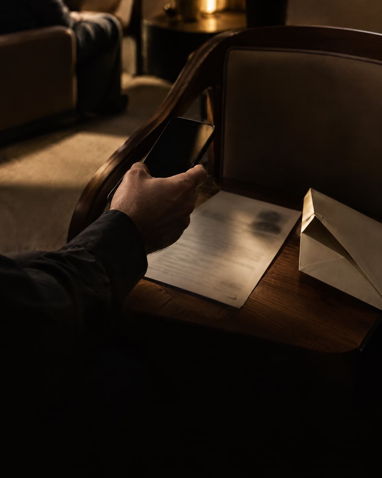 A hand taking a photo of a medical report with a phone, on a kitchen counter.